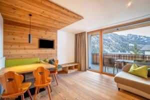 a living room with a table and a couch at Stoana Apt 4-1 in San Giacomo