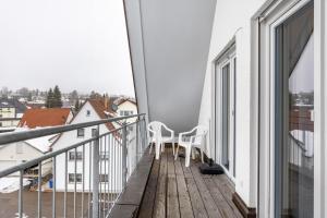 a balcony with two chairs and a table on it at Hohenzollern in Gammertingen