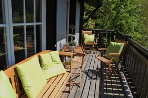 a deck with chairs and a bench on a house at Ferienhaus Sara in Seebach +13 photos