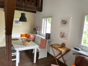 a living room with a white table and two windows at Ferienhaus Sara in Seebach