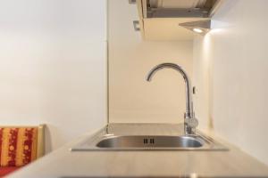 a stainless steel sink in a small kitchen at Runcac Apt Salt in San Vigilio Di Marebbe +16 photos