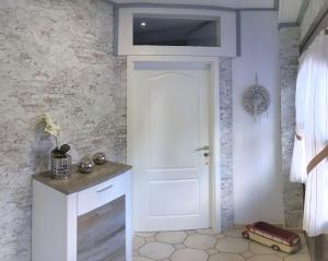 a bathroom with a white door with a television above it at Haus Münsterland in Nordwalde +27 photos