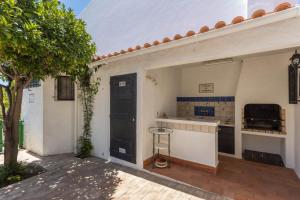 a kitchen with a counter and a black door at Villa Morena in Albufeira