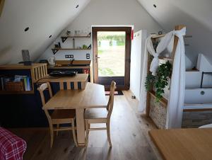 a dining room with a wooden table and chairs at " Al'Coppette " Gîte open-space in Comblain-au-Pont