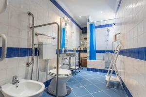 a blue and white bathroom with a toilet and a sink at Villa Morena in Albufeira +26 photos
