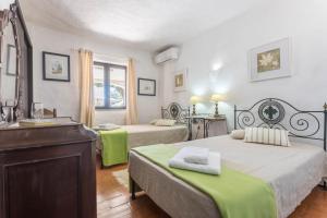 a bedroom with two beds and a dresser in it at Villa Morena in Albufeira