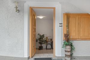 an open door to a room with a potted plant at Rafaser - Apartment Rustika in Feldthurns