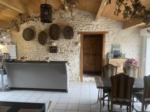 a kitchen and dining room with a table and chairs at Chambres D'hôtes La Marouette in Hiers-Brouage +54 photos
