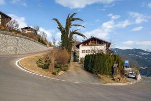 a house on the side of a road at Rafaser - Apartment Rustika in Feldthurns