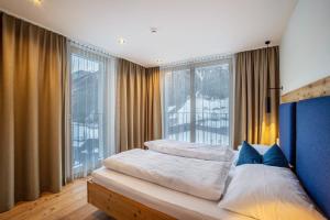 a bedroom with a bed and a large window at Stoana Apt 3-2 in San Giacomo