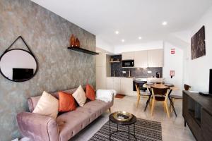 a living room with a couch and a table at Apartamento Brisas Do Mar in Porches