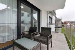 two chairs and a table on a balcony at Fewo im Eichengrund in Rheinhausen