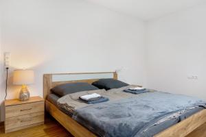 a bed in a bedroom with a nightstand and a bed sidx sidx sidx sidx at Fewo im Eichengrund in Rheinhausen