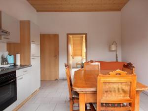 a kitchen and dining room with a table and chairs at Ferienwohnung Graf in Vogtsburg +4 photos