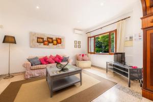 a living room with a couch and a tv at Can Tiro in Islas Baleares