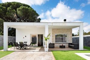 a modern house with a patio and grass at Villa Edén in La Muela