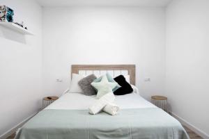 a bedroom with a white bed with pillows at Villa Edén in La Muela +20 photos