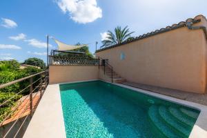 a swimming pool in the backyard of a house at Can Tiro in Islas Baleares