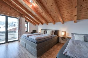 a bedroom with two beds and a large window at Ferienwohnung Alpenvogel in Sonthofen