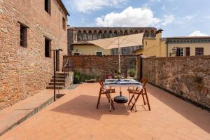a table and chairs with an umbrella on a patio at La Casina di Elisa in Montecarlo