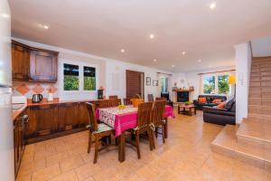a kitchen and living room with a table and chairs at Finca Perello in Felanitx
