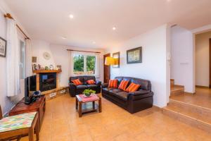 a living room with two couches and a tv at Finca Perello in Felanitx