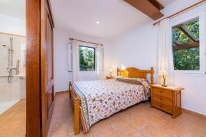a bedroom with a bed and a bathroom with a tub at Finca Perello in Felanitx +26 photos