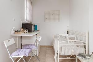 a white room with a bed and a table and chairs at Stenies Little Nook in Andros +15 photos