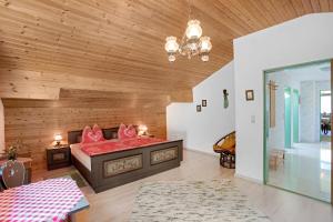 a bedroom with a bed with red sheets at Ferienwohnung Haus Reiteralm in Schneizlreuth
