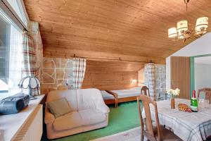 a living room with a couch and a table at Ferienwohnung Haus Reiteralm in Schneizlreuth