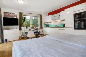 a bedroom with a large bed and a kitchen at Apartment Nordstern in Baabe