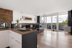 a kitchen and living room with a counter top at Luxus Appartement mit Panoramablick in Sinsheim