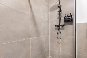 a bathroom with a shower with a glass door at Luxus Appartement mit Panoramablick in Sinsheim