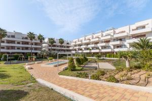 a large apartment building with a playground in front of it at Terrazas de Campoamor Sunrise in Orihuela