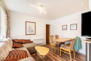 a living room with a couch and a table at Bungalow 179 in Zeulenroda