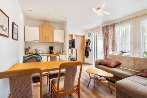 a kitchen and living room with a table and a couch at Bungalow 179 in Zeulenroda