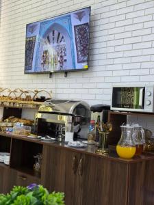 a kitchen with a counter with a coffee maker on it at Gulnaraxanum Boutique Hotel Premium in Bukhara