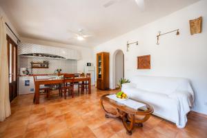 a living room with a white couch and a table at Es Quarteró in Sóller