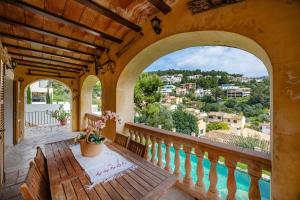 a balcony with a table and a view of a city at Es Quarteró in Sóller