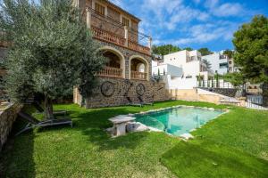 a house with a swimming pool in the yard at Es Quarteró in Sóller