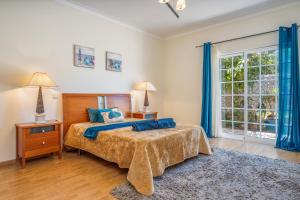 a bedroom with a bed and a large window at Casa Village in Senhora do Verde +27 photos