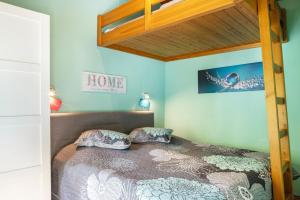 a bedroom with a bed with a wooden bunk bed at Ferienhaus Sweet Home in Machtlos