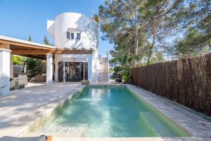 a swimming pool in the backyard of a house at Casa Cala Santanyí in Santanyi