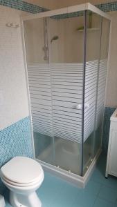 a glass shower in a bathroom with a toilet at Torre dell'orso centralissima vista mare in Torre dell'Orso +24 photos
