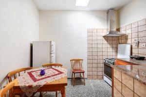 a kitchen with a table and chairs and a refrigerator at Casa de Berta in Vallehermoso