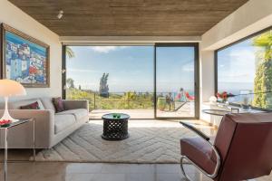 a living room with a couch and a large window at Villa Miramar in Puntagorda