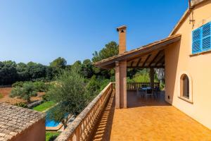 a patio of a house with a table and chairs at Sa Plana in Son Servera