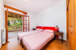 a bedroom with two beds and a window at Sa Plana in Son Servera +36 photos