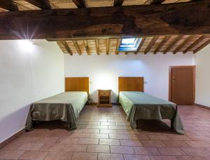 a room with two beds and a window at Podere Simonetta - A9 in Cecina