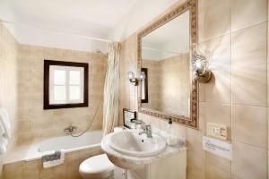 a bathroom with a sink and a toilet and a mirror at Casita Ariadna in Tijarafe +23 photos